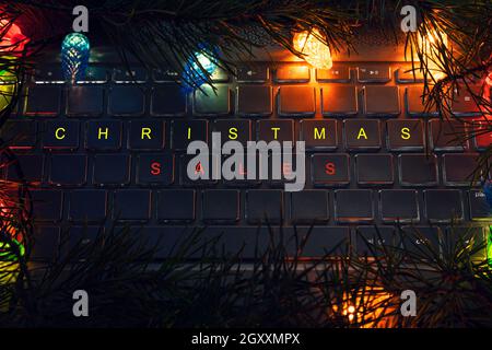 Computer keyboard with Christmas keys - holiday concept. christmas sales lettering on laptop keyboard Stock Photo