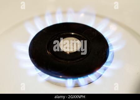 Increase in the price of gas. The concept of problems in the Russian economy. The ruble is burning on a gas stove. The sale of gas. Expensive gas supp Stock Photo