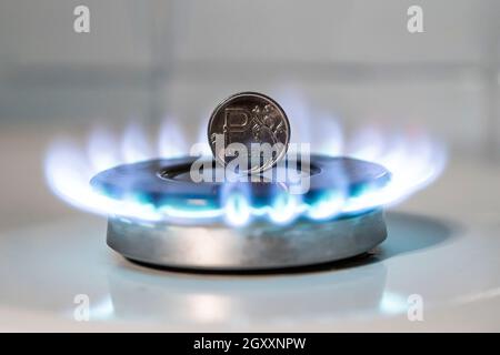 Increase in the price of gas. The concept of problems in the Russian economy. The ruble is burning on a gas stove. The sale of gas. Expensive gas supp Stock Photo