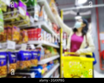 Blurred images of an asian girl  shopping in supermarket due to panic shopping because of Corona-Virus, Covid-19. Business and healthcare concept.
