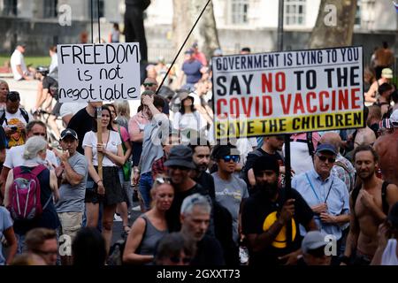 Protesters hold up placards at a demonstration against government lockdown restrictions in Parliament Square in central London on June 14, 2021.