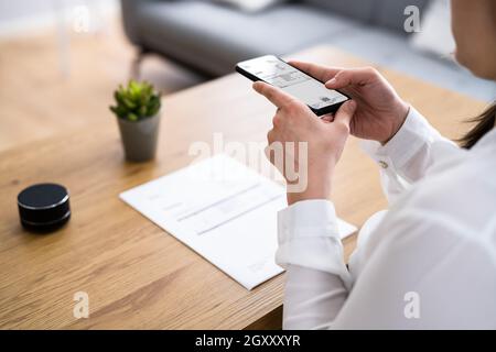 Taking Invoice Document Photo Using Phone Or Smartphone Stock Photo