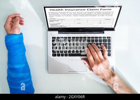 Injured Worker Compensation. Broken Arm In Office Stock Photo