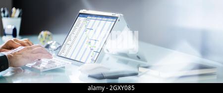 Convertible Laptop Gantt Chart Software And Digital Agenda Stock Photo
