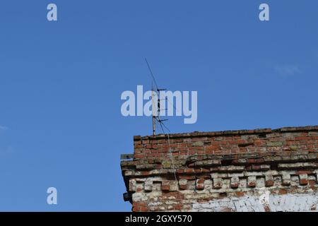 The television antenna on the rooftop. Means of reception of a signal. Stock Photo