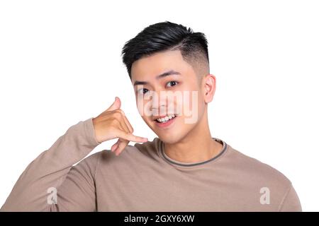 Young man doing phone gesture like says call me back Stock Photo