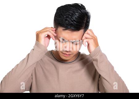 Young Man having headache isolated on white Stock Photo
