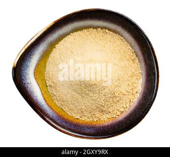 top view of granulated coconut sugar in ceramic bowl isolated on white background Stock Photo
