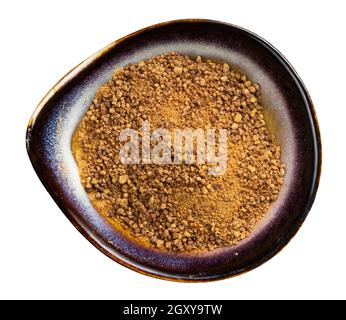 top view of granulated coconut blossom sugar in ceramic bowl isolated on white background Stock Photo