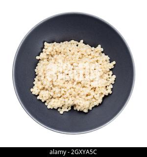 top view of boiled israeli pearl couscous in gray bowl isolated on white background Stock Photo