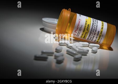 Hydrocodone Pills and Prescription Bottle with Non Proprietary Label. No model release required - contains fictitious information. Stock Photo