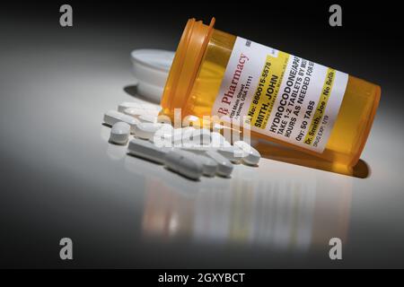 Hydrocodone Pills and Prescription Bottle with Non Proprietary Label. No model release required - contains fictitious information. Stock Photo