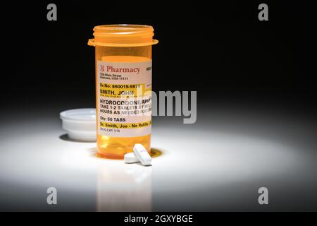 Hydrocodone Pills and Prescription Bottle with Non Proprietary Label. No model release required - contains fictitious information. Stock Photo