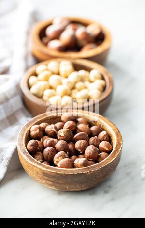 Peeled roasted hazelnut kernels in bowl. Stock Photo