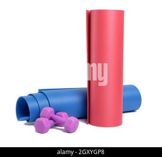 pair of plastic kg dumbbells and yoga mat isolated on white background Stock Photo