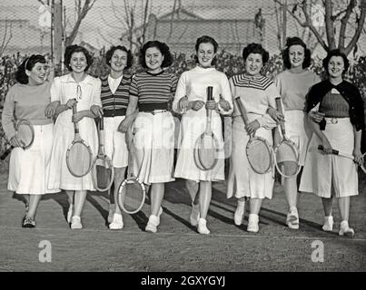 Sport in Argentina in the 1930s – here a group of female tennis players pose at the Club de Gimnasia y Esgrima, Buenos Aires, Argentina in the 1930s. Club de Gimnasia y Esgrima (GEBA) is an Argentine multi-sports club placed in the city of Buenos Aires. It is one of the oldest in the country, established in 1880. This photograph is from a print from a scrapbook/photo album assembled in the 1940s/50s by an Argentinian sports enthusiast – a vintage 1930s photograph. Stock Photo