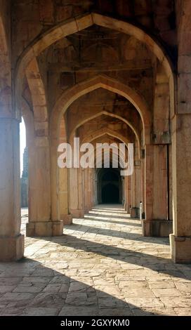 Arched corridor. Vintage black and white photo. Round tunnel. Ladder down. Stock Photo