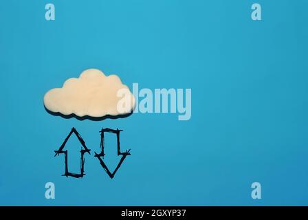 White cloud with up and down arrow on blue background Stock Photo