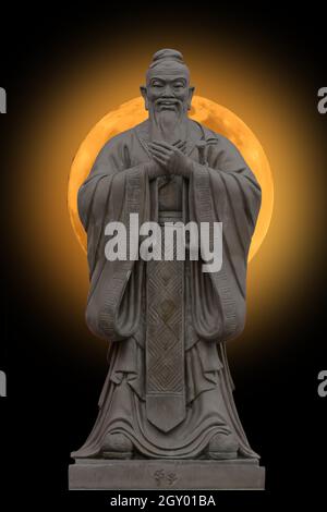 Stone statues on super moon yellow background. Stock Photo