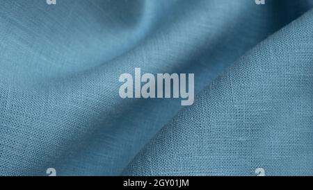 Linen fabric, blue background. Soft linen blue fabric texture. Textured fabric background. Macro with shallow dof Stock Photo