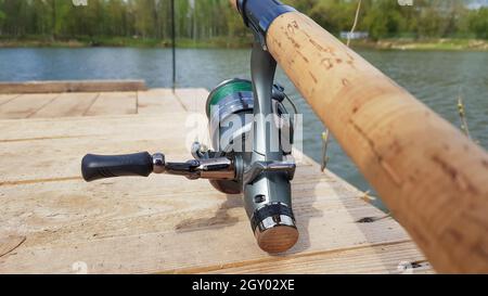 Carp fishing rod isolated on the lake and wooden bridge. Carp feeder  spinning reel close up. Fishing for carp on the lake. Fisherman's equipment Stock  Photo - Alamy