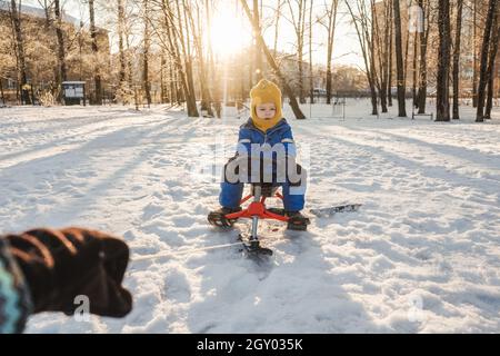 Mother and baby on Snowmobile Stock Photo - Alamy