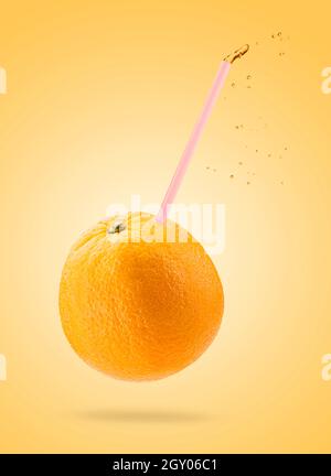 Orange fruit with drinking staw on colored background Stock Photo
