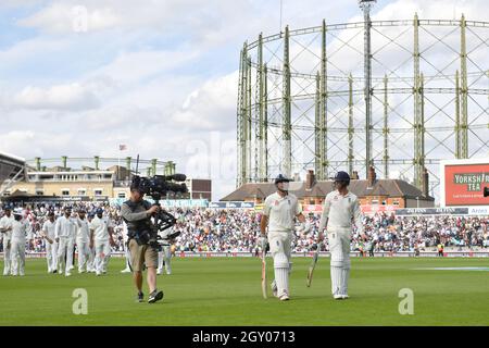England’s Alastair Cook walks off the field with Keaton Jennings at Tea during the test match at The Kia Oval, London. Stock Photo