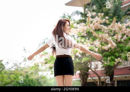Portrait of asian student university uniform beautiful girl relax and smile. Happy Asian girl in campus Stock Photo