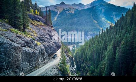 Mountain with snow next to a dirt road along the Denali Highway on a ...