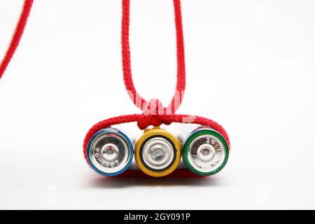 Battery bound with red rope. Energy concept Stock Photo - Alamy