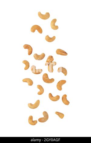 Cashew nuts falling isolated on white background with clipping path. Stock Photo