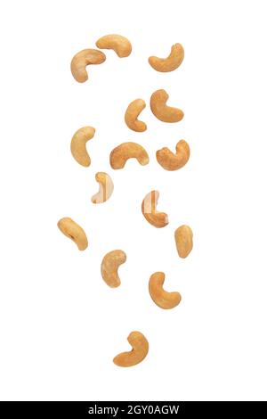 Cashew nuts falling isolated on white background with clipping path. Stock Photo