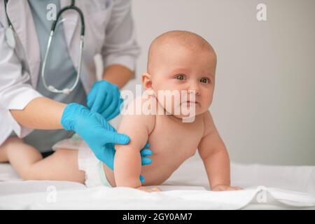 Newborn being examined by a healthcare professional Stock Photo
