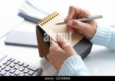Blank notepad for writing planning of day in female hand with pen Stock Photo