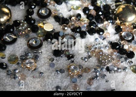 sparking crystal beads and buttons lay on the table for made gift or decoration Stock Photo