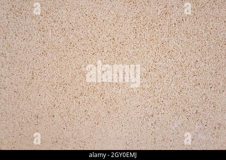 Decoration of an exterior wall decorated with rough concrete and painted with a light pink color. Background with copy space. Concept Stock Photo