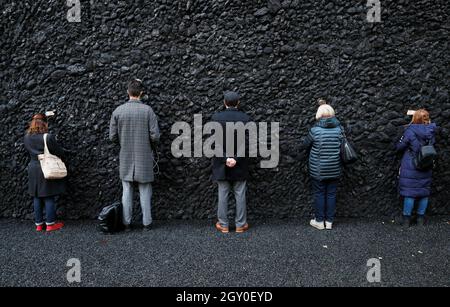 People take part in a performance by Marina Abramovic next to her artwork "Crystal Wall of Crying" at Babyn Yar, the site of one of the biggest massacres of the Holocaust during World War Two, in Kyiv, Ukraine October 4, 2021. Picture October 4 ...