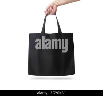 Hand holding blank black fabric canvas bag isolated on white background with clipping path, eco concept. Stock Photo