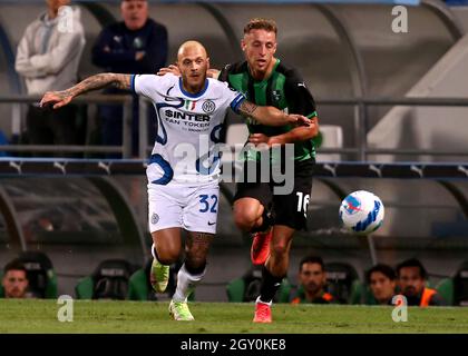 REGGIO NELL'EMILIA, ITALY - OCTOBER 02: Federico Dimarco of FC Internazionale competes for the ball with Davide Frattesi of US Sassuolo ,during the Serie A match between US Sassuolo v FC Internazionale at Mapei Stadium - Citta' del Tricolore on October 2, 2021 in Reggio nell'Emilia, Italy. (Photo by MB Media) Stock Photo