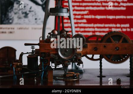 Piece of old equipment with gears displayed at the Science and Technology Museum in Romania Stock Photo