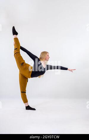 Young blonde blue-eyed dancer woman on white background Stock Photo