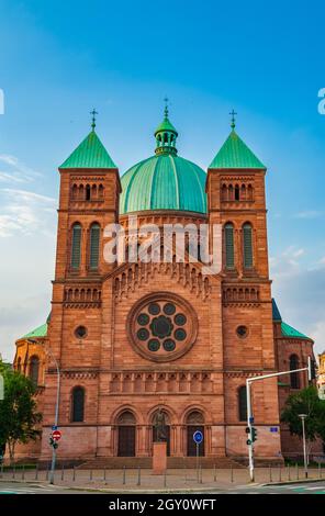 Lovely view of the Saint-Pierre-le-Jeune Catholic Church with its heavy and imposing dome in Strasbourg, France. The main facade, built with red rose... Stock Photo