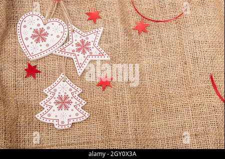 wooden Christmas toys on burlap with artificial snow Stock Photo