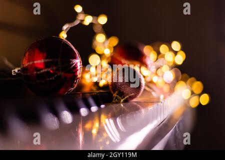 Festive decor on piano keys indoors, closeup. Christmas music Stock Photo