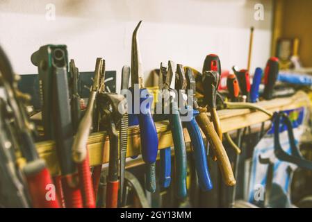 Tools in the workshop. A set of working tools on the shelf. Special equipment for work. Stock Photo