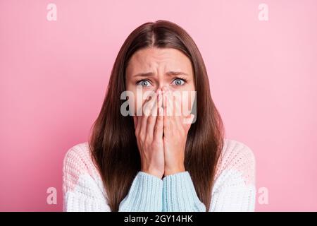 Photo of shocked scared young lady hold hands face cover mouth isolated on pastel pink color background Stock Photo