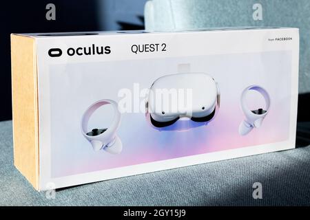 Child holds new VR head set box. A new generation gaming device for entertainment and sport. Oculus Quest 2. Stock Photo