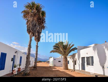 High angle shot of one-floor white buildings with palm trees on a sunny day Stock Photo