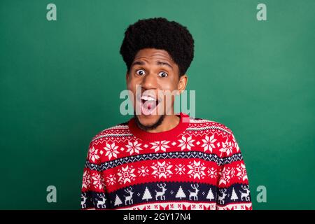 Photo of impressed pretty guy dressed print pullover smiling open mouth isolated green color background Stock Photo